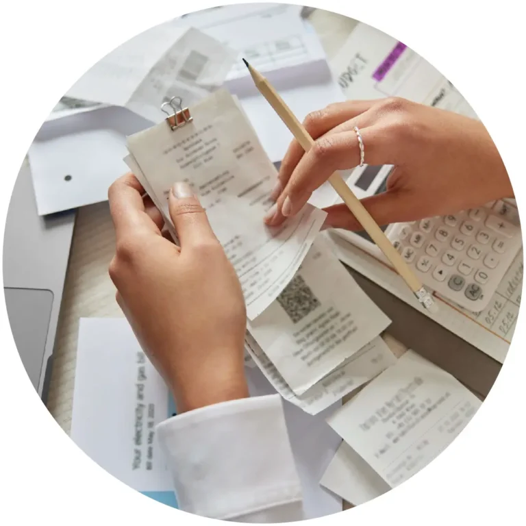 Hands reviewing and organizing receipts and financial records