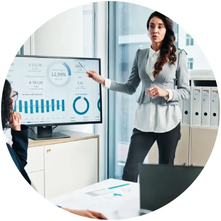 Female accounting professional presenting financial charts at a whiteboard