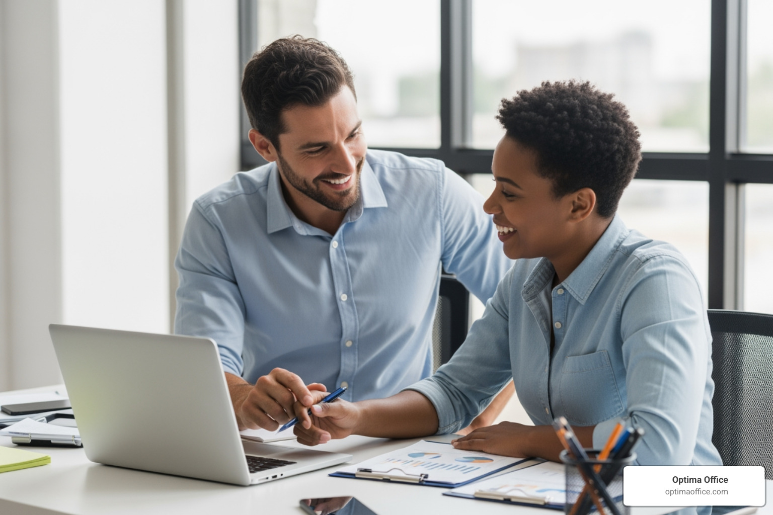 A manager and employee sitting together in a bright office setting SMART goals for the quarter - performance management A manager and employee sitting together in a bright office setting SMART goals for the quarter - performance management